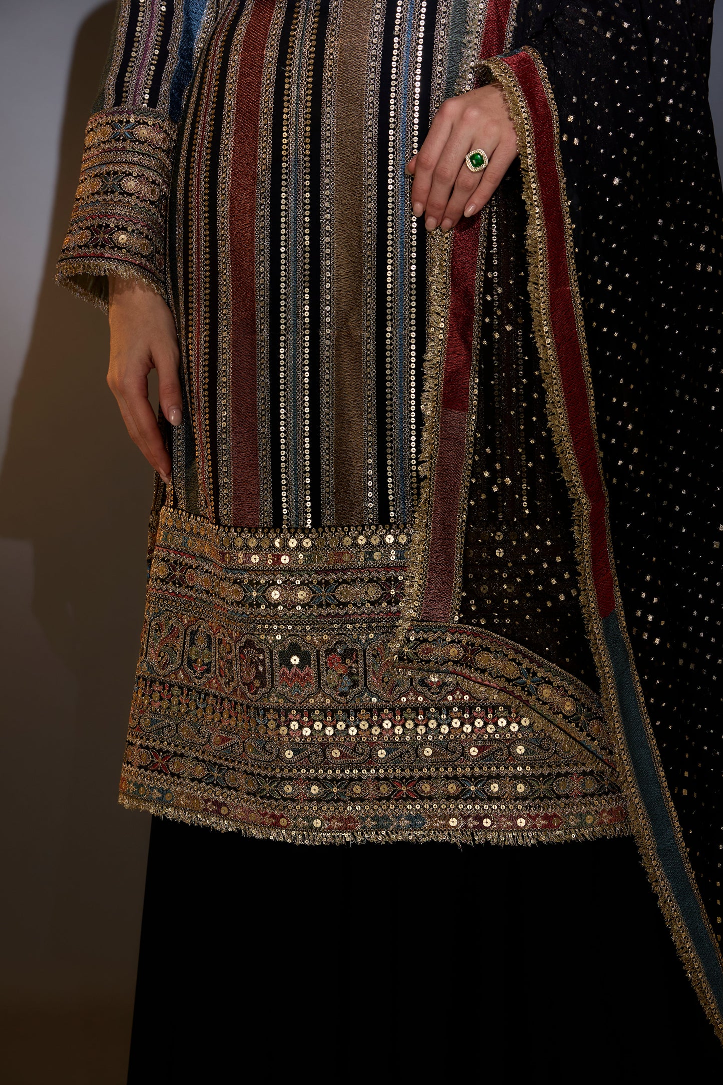 multi color striped suit with intricately done thread and zari work paired with sharara and dupatta