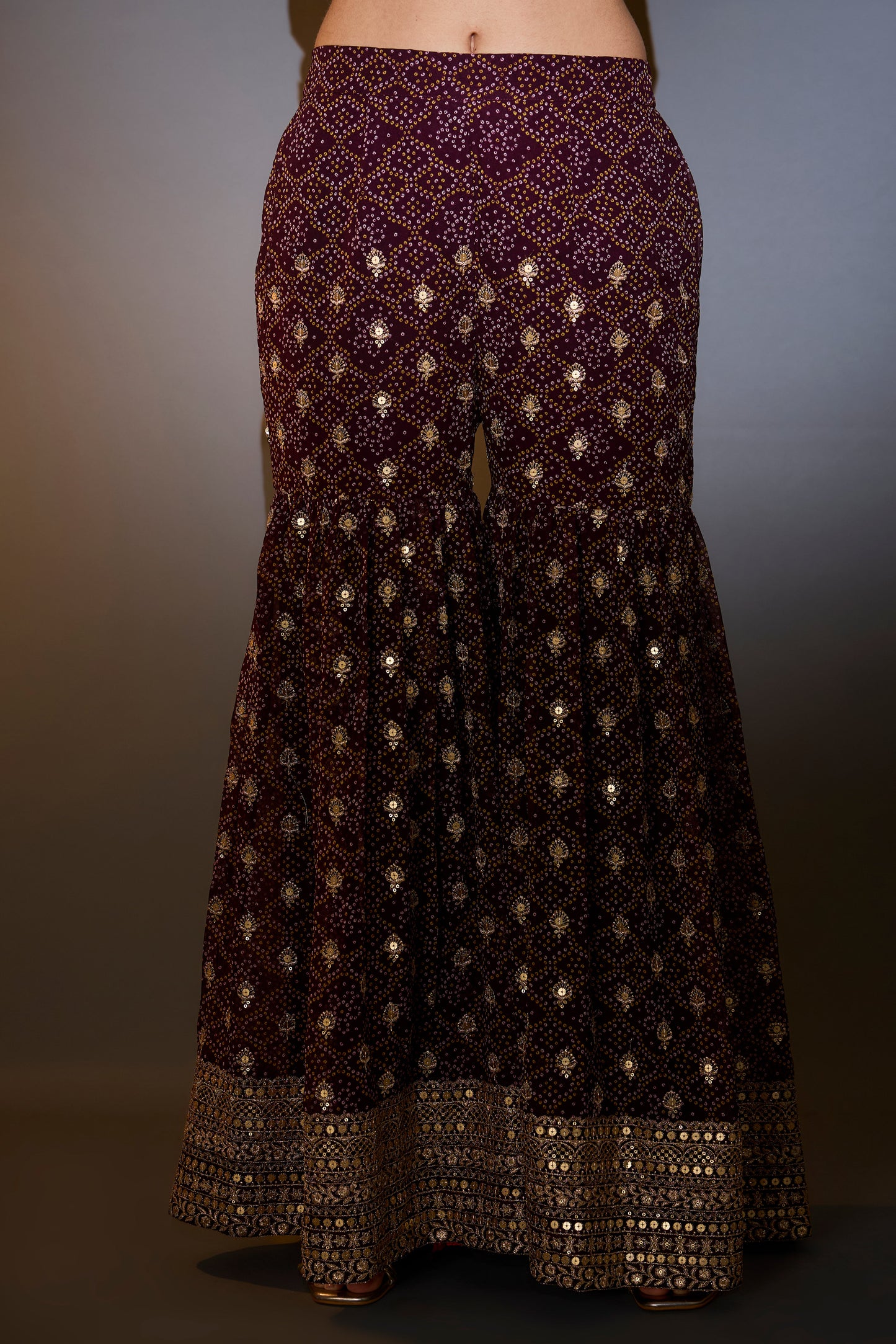 wine kaftan with sharara with intricate aari and sequins work on the neck ghera and bottom