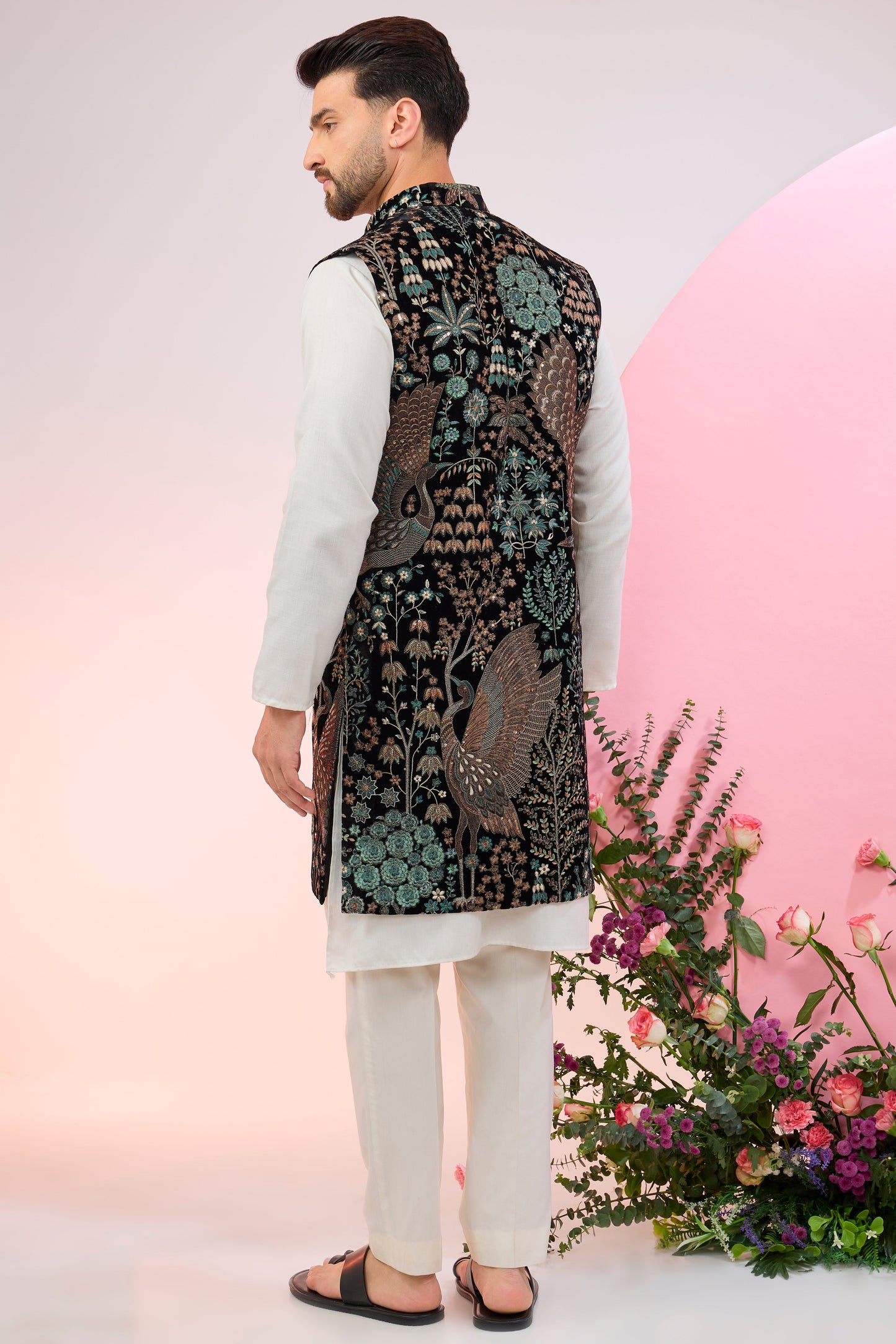 black long jacket on velvet with intricate flora and fauna embroidery