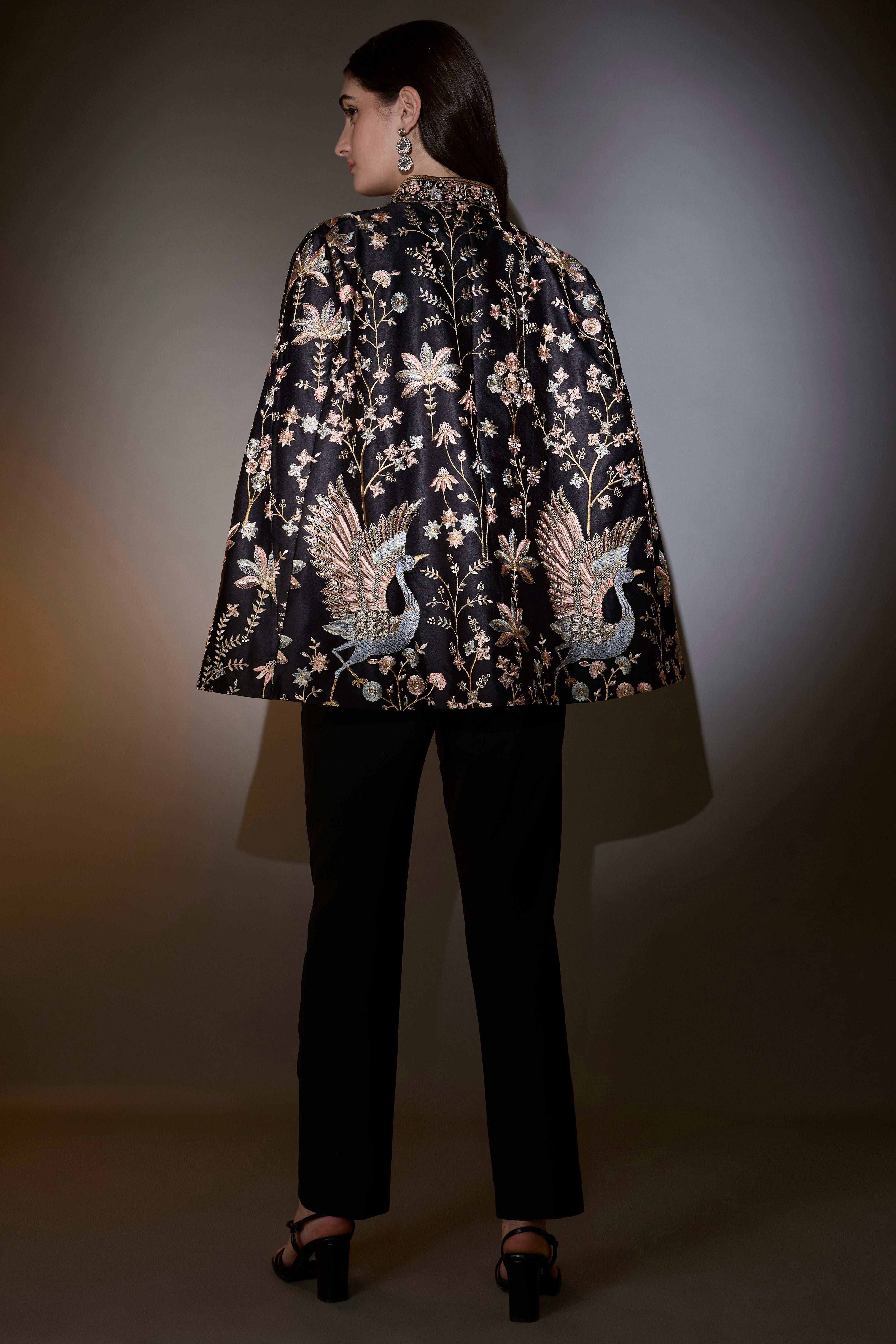 black cape with intricate multi thread work elevated by swan motifs