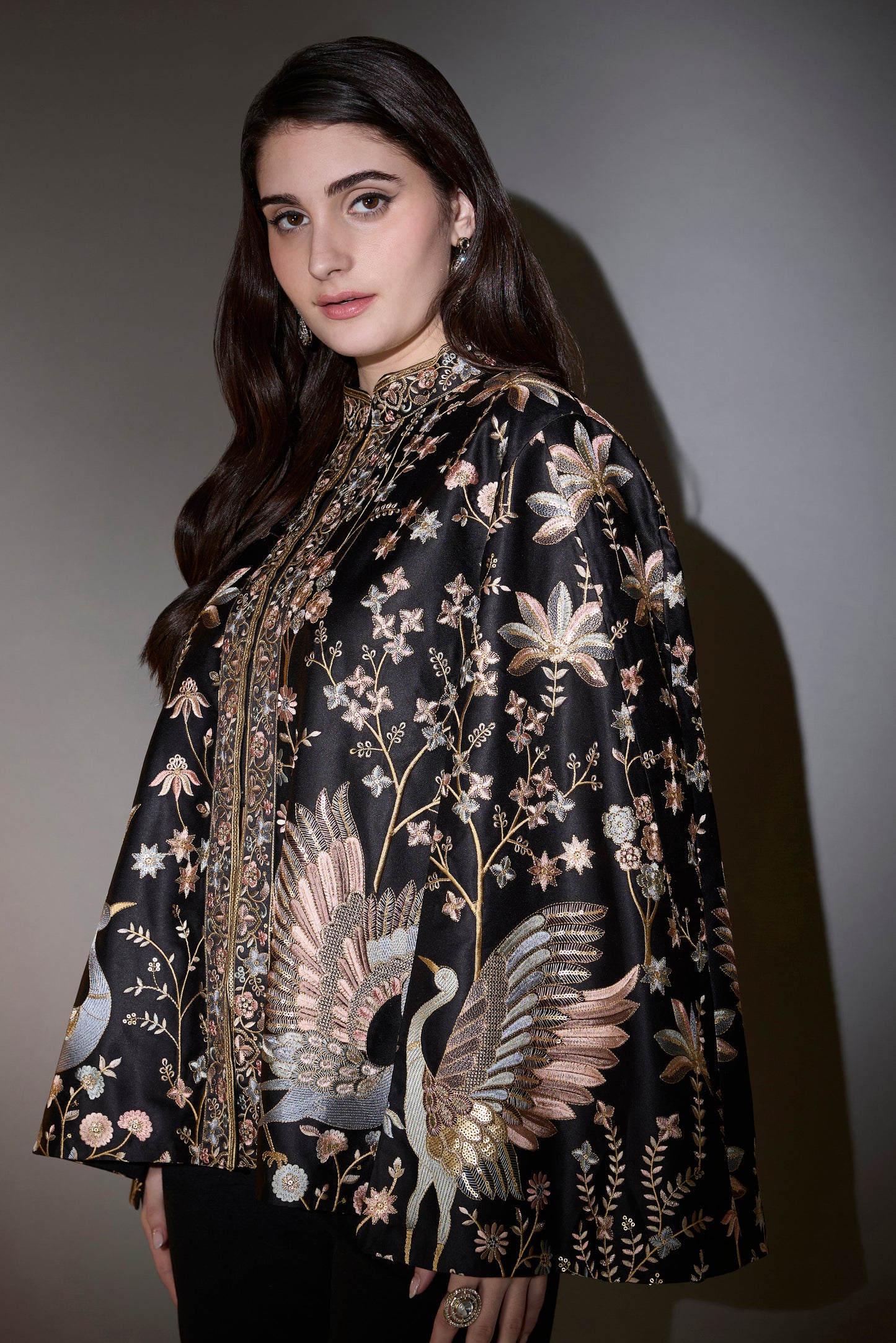 black cape with intricate multi thread work elevated by swan motifs